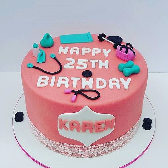 a pink birthday cake with the words happy 25th birthday written on it and various accessories