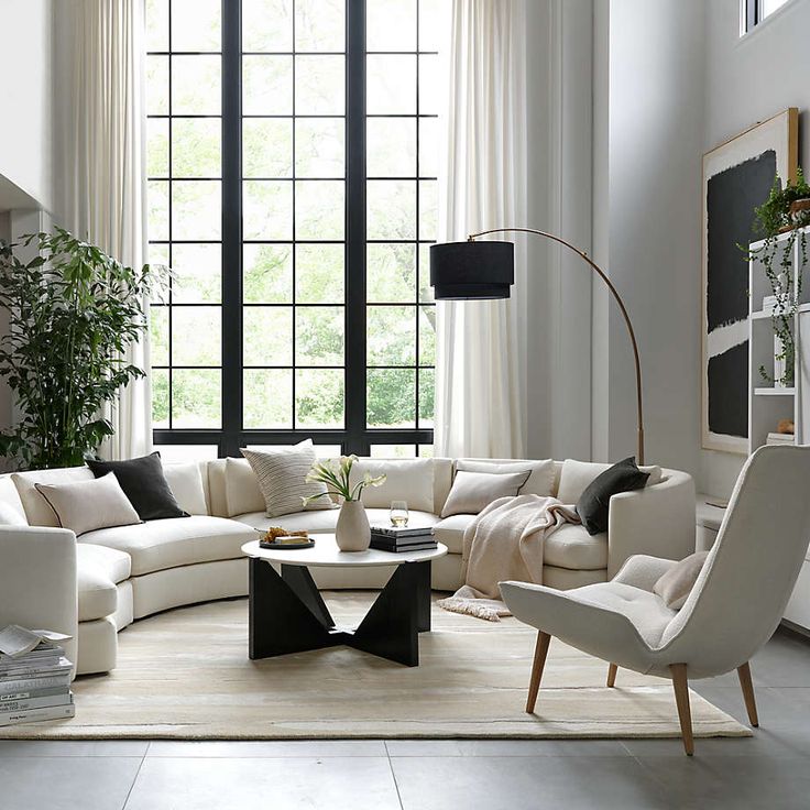 a living room filled with furniture and a large window