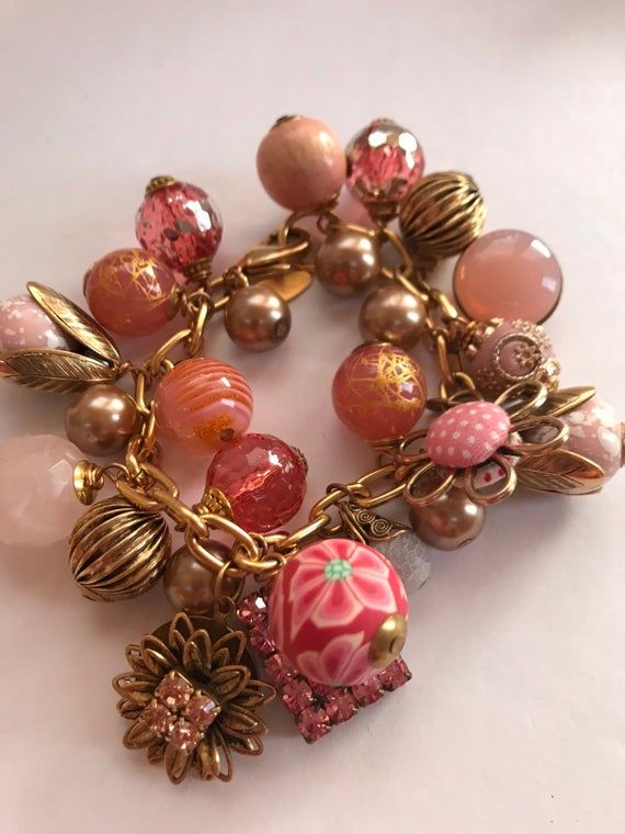 Lenora Dame charmingly pink baubly charm bracelet Charming Pink Flower Jewelry, Charming Pink Flower-shaped Jewelry, Whimsical Pink Adjustable Bracelets, Vintage Pink Jewelry With Charms, Vintage Pink Charm Jewelry, Pink Adjustable Whimsical Bracelets, Pink Vintage Jewelry With Charms, Whimsical Pink Beaded Bracelets, Pink Whimsical Beaded Bracelets