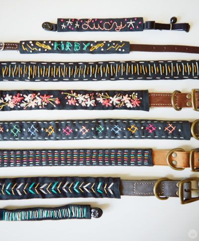 five different types of belts are lined up on a white surface, one is black and the other has multicolored designs