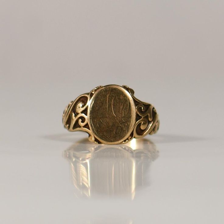 Crafted in the opulence of the Victorian era, this exquisite 10K Yellow Gold Signet ring showcases timeless elegance with its intricate design. The ring features a distinguished "DL" monogram engraved on the face, adding a personalized touch to its luxurious aesthetic. A symbol of refined taste and historical charm, this Victorian masterpiece seamlessly combines craftsmanship and style in a radiant tribute to the fashion of the 19th century. Ring Size: 11.5 Metal Type: 10K Yellow Gold (Tested) Weight: 7g Hallmarks: None Engraving: "DL" (Worn out) Width: 14.70mm Finger to Top of Ring: 1.40mm We look forward to providing you with an exceptional experience and helping you find more exquisite additions to your collection. *More Pictures Available on Request* R-124CFT-N115 1800s Jewelry, Mens Ring Designs, Luxurious Aesthetic, Historical Jewellery, Gold Signet Ring, Intricate Design, Victorian Era, Signet Ring, The Fashion