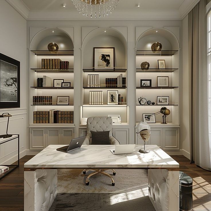 a home office with built - in bookcases and a chandelier