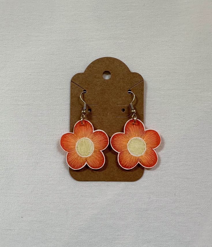 Handmade shrinky dink flower dangle earrings! Nickel-free Orange Flower Earrings, Dangle Flower Earrings With Floral Print For Gift, Dangle Flower Earrings With Floral Print As Gift, Handmade Orange Flower Earrings, Adjustable 3d Flower Earrings, Adjustable Handmade Flower Earrings, Floral Print Dangle Earrings For Gift, Cute Nickel-free Flower Shaped Earrings, Retro Flower Shaped Earrings As Gift