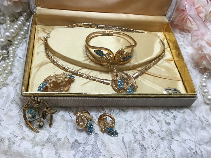 Beautiful complete vintage jewelry set. All gems are intack. Set includes necklace, spring action cuff bracelet, screw earrings, and two brooches. Box is marked Original by Carla. Vintage Gold Jewelry Sets For Gift, Vintage Gold Metal Jewelry Sets, Handmade Vintage Jewelry Sets As Gift, Handmade Vintage Jewelry Sets For Gift, Vintage Jewelry Sets With Matching Earrings For Formal Events, Vintage Jewelry Sets With Matching Earrings For Formal Occasions, Vintage Gold Jewelry Sets For Wedding, Retro Metal Jewelry For Anniversary, Vintage Jewelry Sets For Wedding