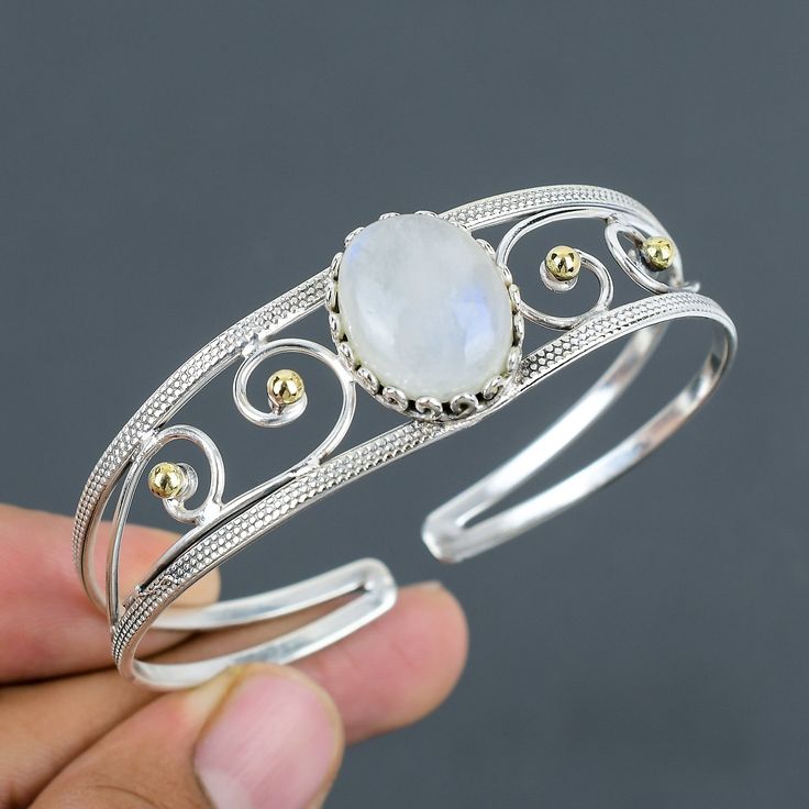 Note: Due to the natural formation of this gemstone. Slight variation in design and color are to be expected. Rainbow Moonstone Cuff Bracelet 925 Sterling Silver Bangle Adjustable Cuff 18K Gold Plated Handmade Top Quality Gemstone Bangle Gift For Him SKU  : VC-25 Handmade Cuff Bracelet Gemstone : Rainbow Moonstone Stone Shape : Oval Metal Purity : 925 Sterling Silver Cuff Bracelet Size : Adjustable Rainbow moonstone is thought to bring balance, harmony and hope while enhancing creativity, compas Elegant Moonstone Cuff Bangle Bracelet, Elegant Moonstone Bangle Cuff Bracelet, Elegant Adjustable Moonstone Cuff Bracelet, Moonstone Gemstone Cuff Bracelet Bangle, Elegant White Gemstone Cuff Bracelet, Handmade Elegant Moonstone Cuff Bracelet, Cuff Bracelets Handmade, Gemstone Bangle, Moonstone Stone