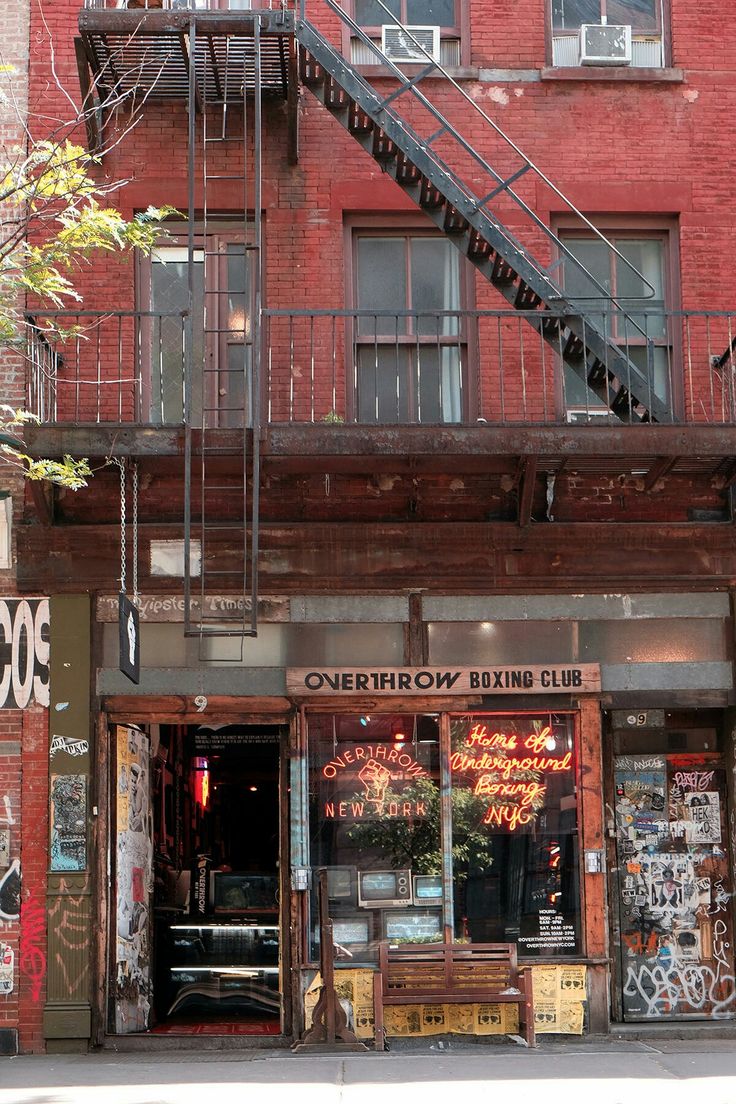 an old building with graffiti on it and stairs leading up to the second floor above