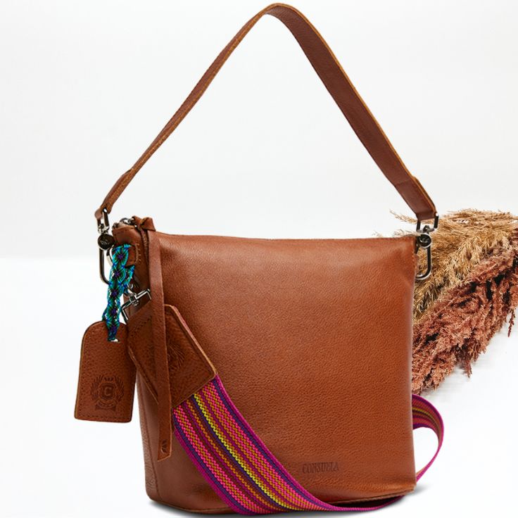 The little sister to the Hobo bucket bag, our Wedge is great to store all your essentials. This bag’s interior pockets and roomy layout make it easy to hold everything you need by your side with the crossbody strap or on hand with the leather shoulder strap Brandy cognac leather exterior, handles, and trim Includes an Brandy leather bag tag secured with a hand-woven friendship bracelet Features interior embroidered patch Interior slide pocket, zipper pocket, and hook-clip lanyard Includes two de Cognac Hobo Bag With Detachable Strap For On-the-go, Detachable Handle Bag Strap For Everyday Use, Cognac Bucket Bag For On-the-go, Versatile Bucket Bag With Leather Lining For Everyday Use, Everyday Leather-lined Crossbody Bucket Bag, Brown Top Handle Bucket Bag For On-the-go, Versatile Brown Bucket Bag With Leather Lining, Versatile Cognac Bucket Bag For Everyday, Leather Handles Bag Strap For Everyday Use