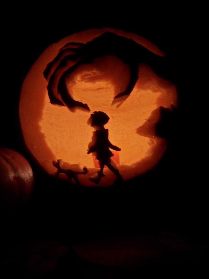 a pumpkin carved to look like a child's silhouette