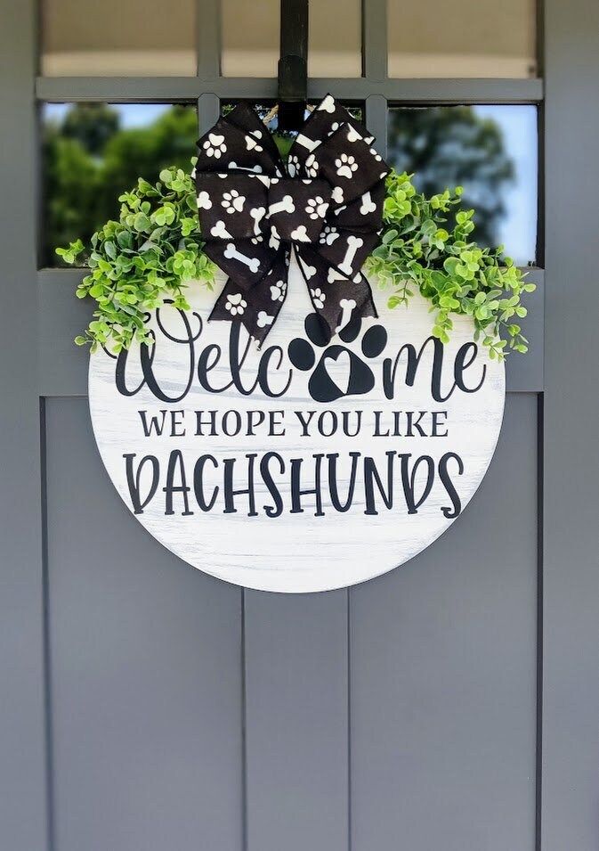 a welcome sign hanging on the front door