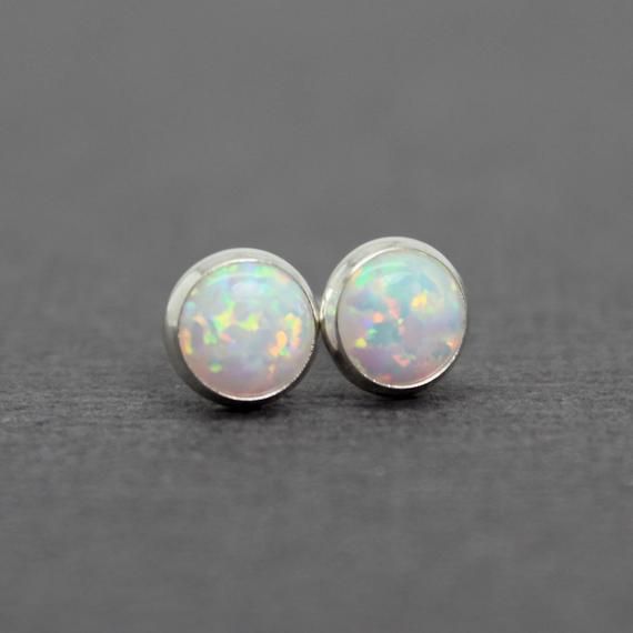 These opal stud earrings are beautiful.  They feature a single 6mm simulated opal cabochons.  Hand bezel set in my studio.  6mm Simulated Opal Round CabochonsSolid 925 Sterling Silver or 14/20 Gold FilledArtisan Made in TexasArrives thoughtfully packaged in a signature jewelry boxCheck out all of my opal earrings: https://www.etsy.com/shop/KMBankston/search?search_query=opal+earring&order=date_desc&view_type=gallery&ref=shop_search~About Me:My name is Kathy Bankston, and I am a metal Minimalist Iridescent Round Jewelry, Hypoallergenic Round Opal Jewelry, Minimalist Ethiopian Opal Round Jewelry, Dainty Round Ethiopian Opal Jewelry, Classic Opal Jewelry As A Gift, Classic Opal Jewelry For Gifts, Dainty Ethiopian Opal Round Jewelry, Classic Opal Cabochon Jewelry, Classic Opal Birthstone Jewelry