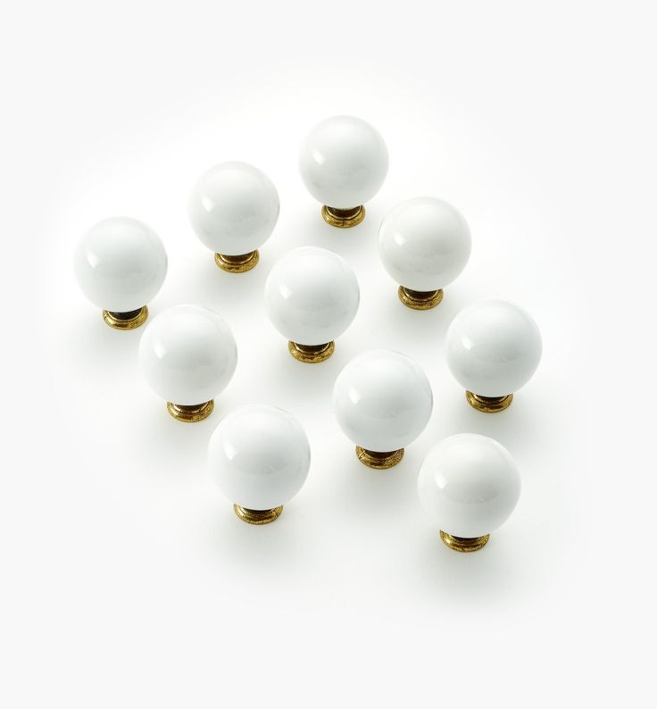 several white and gold knobs on a white surface