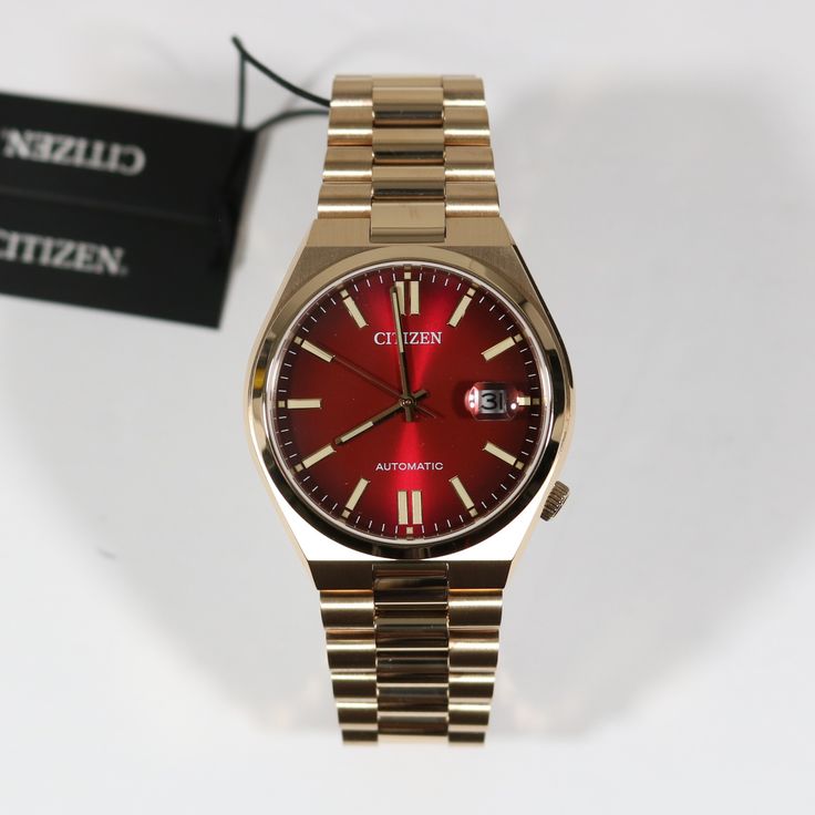 Item No. NJ0153-82X Citizen Tsuyosa Automatic Gold Tone Steel Red Dial Watch NJ0153-82X Watch Features: Automatic Movement Caliber: 8210 21 Jewels 40 Hours Power Reserve Sapphire Crystal Gold Tone Stainless Steel Case Gold Tone Stainless Steel Bracelet Date Display Analog Display Fold Over Clasp Exhibition Case Back Push Pull Crown Luminous Hands Luminous Markers Red Dial Fixed Bezel Case Diameter: 40 mm Case Thickness: 11.7mm Water Resistance: 50 Meters Free Priority Shipping on all orders in c Citizen Tsuyosa, Authentic Watches, Steel Bracelet, Fold Over, Sapphire Crystal, Stainless Steel Bracelet, Stainless Steel Case, Wrist Watch, Gold Tones