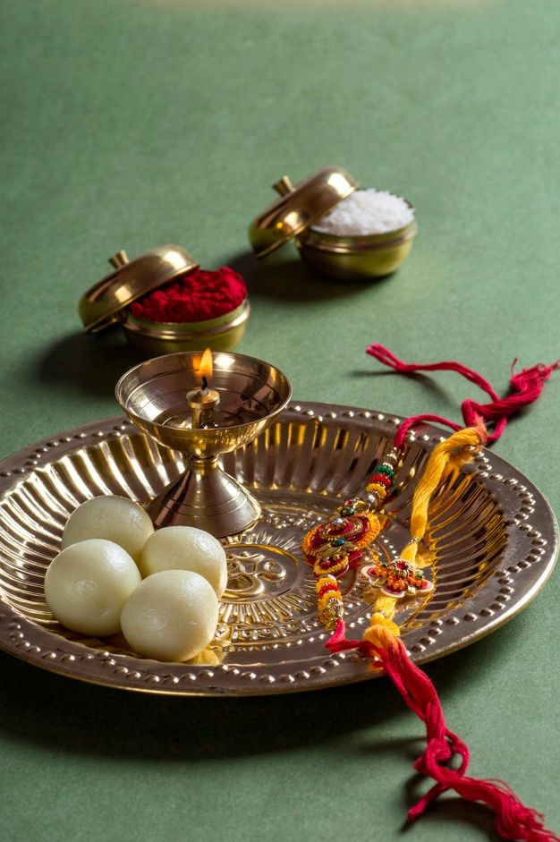 an assortment of food items on a metal tray with red tassels next to it