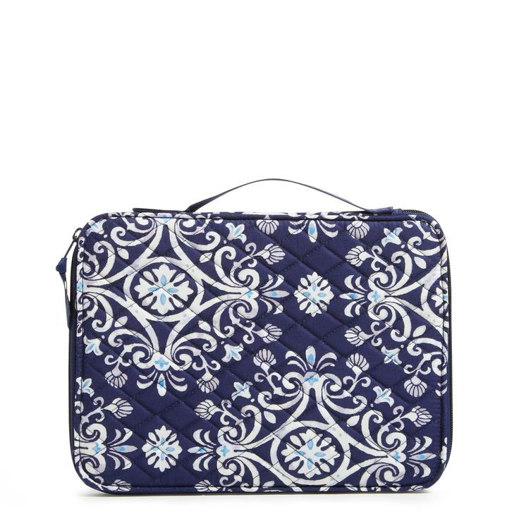 a blue and white bag with an ornate design on the front, it's zippered closure