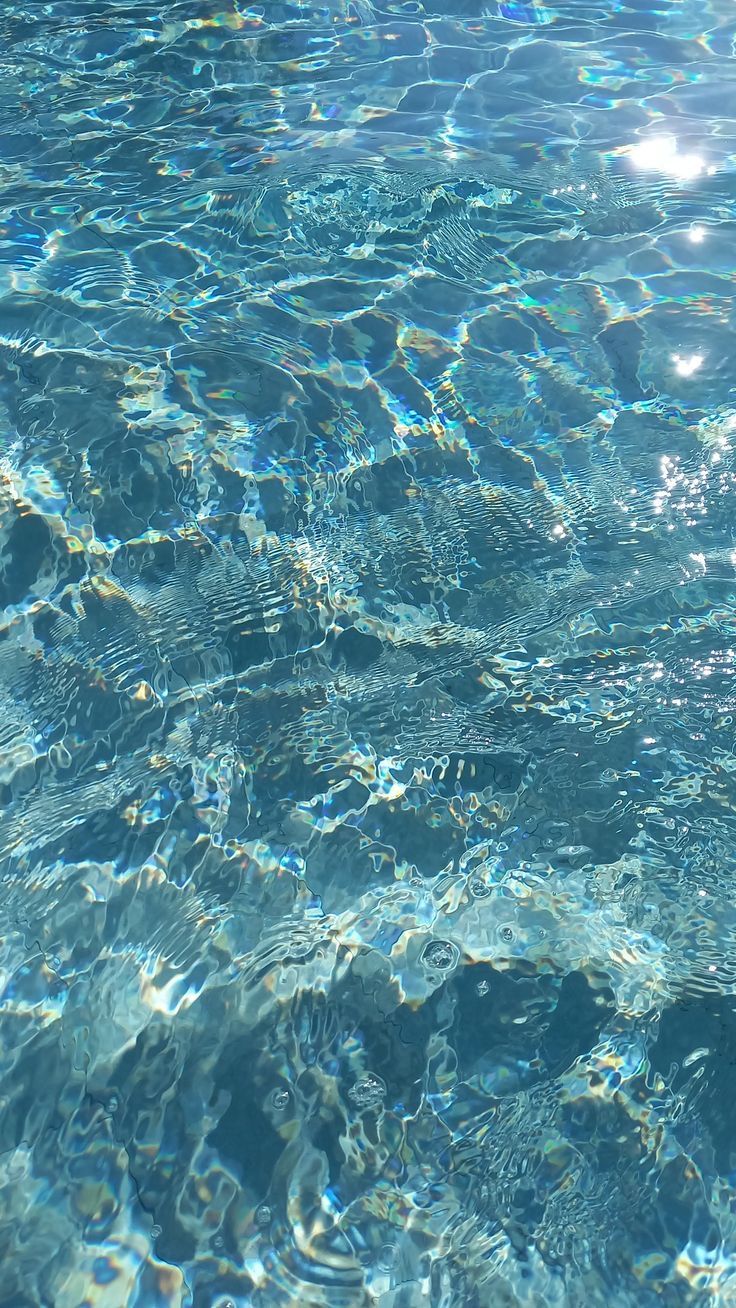 the sun shines brightly through clear blue water