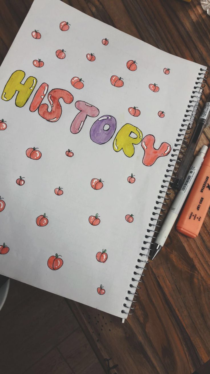 a notebook with the words history written on it next to a cup of coffee and an orange marker