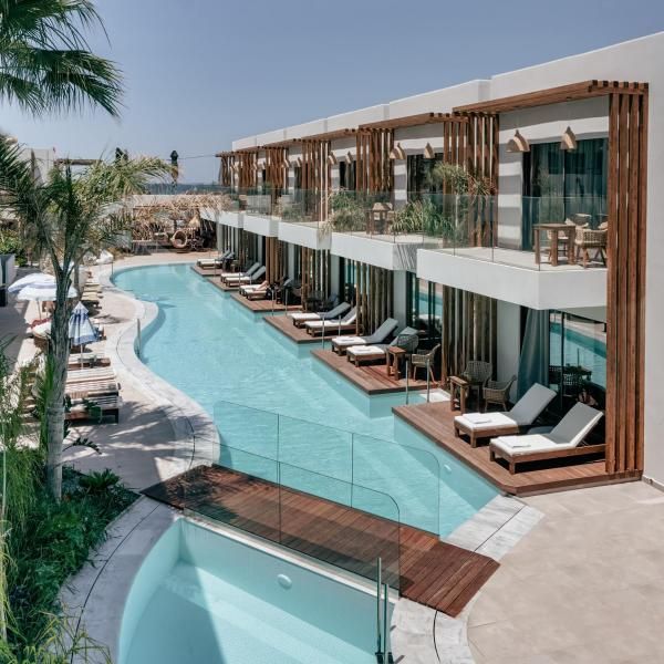 an outdoor swimming pool with chaise lounges next to it