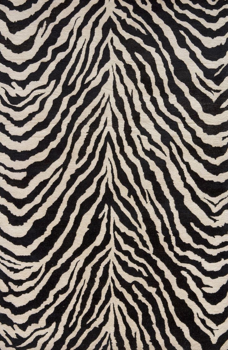 an animal print rug with black and white stripes