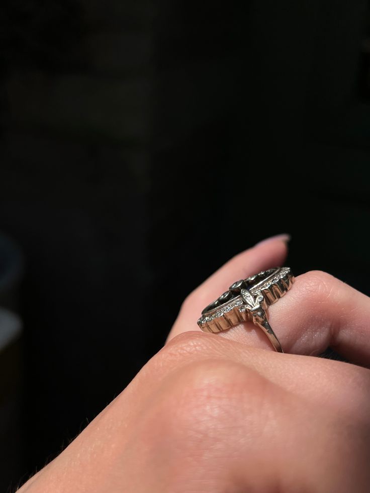 During the Victorian era, navette or “little ship” rings were highly en vogue, and were the perfect statement pieces for elegant nights out or celebrations. This rare Art Deco ring emulates the understated glamor of the navette design, creating a gorgeous and memorable silhouette! Crafted circa 1920’s in 18 carat white gold, this ring features a truly unique synthetic blue topaz gem with a smooth, flat cut. Just look at that hue! The dimensions of color in this topaz is remarkable, and there is Timeless Marquise Sterling Silver Ring, Luxury Rose Cut Emerald Shape Diamond Rings, Luxury Emerald Cut Rose Diamond Ring, Art Deco Diamond Cluster Ring With 17 Jewels, Elegant Marquise Sterling Silver Ring, Luxury Marquise Cut Ring For Gift, Elegant Platinum Signet Ring With Polished Finish, Luxury Oval Cluster Ring With Single Cut Diamonds, Platinum Diamond Cut Rings For Evening