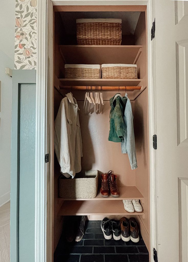 an open closet with clothes and shoes in it