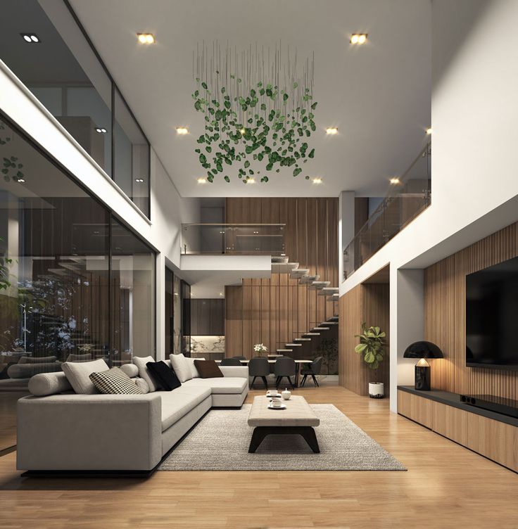 a modern living room with wood floors and white furniture, including a large sectional couch