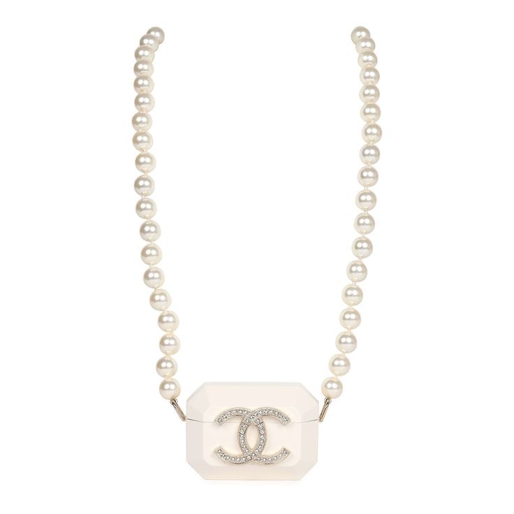 This Chanel resin crystal pearl Airpod Pro case necklace is crafted from resin material with a large gold and crystal CC on the front of the Airpod case. The case features a long single strand of pearls and an interwoven chain of light gold tone and black lambskin leather to be worn as a strap or a necklace. This necklace also features an opening on the base for a charging cord.Collection: 2021Origin: ItalyCondition: New and never wornAccompanied by: Chanel pouch, ribbon and carebookMeasurements Chanel Pouch, Airpod Pro Case, Airpod Pro, Charging Cord, Airpod Case, Resin Material, Gold Diamond Rings, Crystal Pearls, Lambskin Leather