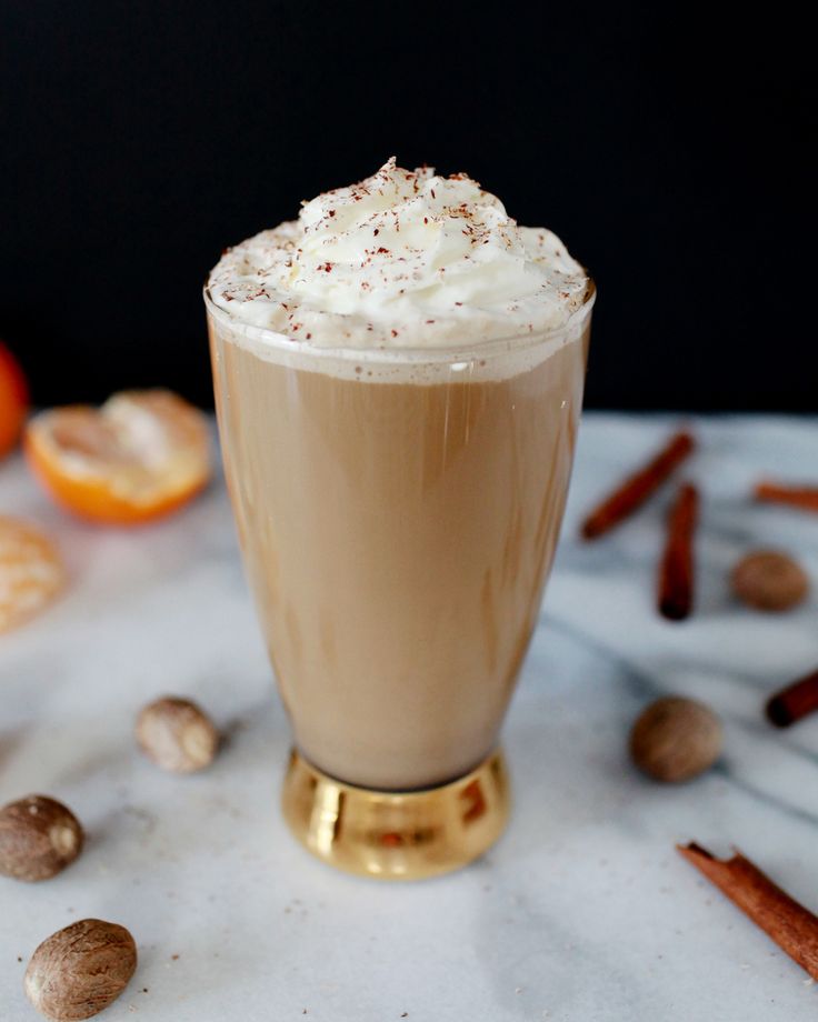 there is a drink with whipped cream and nuts on the table