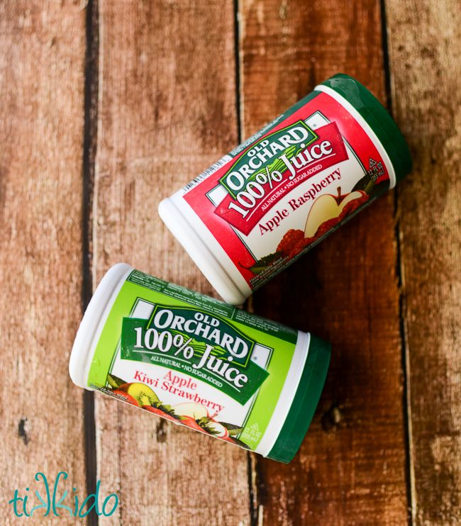 two yogurt cups sitting on top of a wooden table