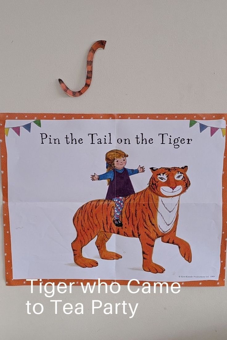 there is a sign that says pin the tail on the tiger with a girl on top