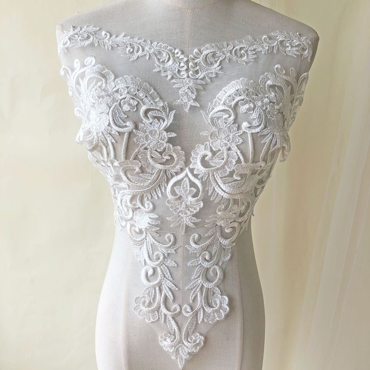 a mannequin with white lace on it