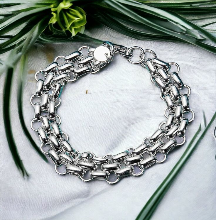 "Upgrade your style with our Multilayer Wide Silver Chain Bracelet. Affordable silver jewelry featuring a beautiful 10mm interlocking chain, electroplated for a stunning look. Perfect for adding a touch of elegance to any outfit. To ensure it stays in place all day, it comes with a large lobster clasp closure that makes putting it on and removing it a breeze. And while it is only available in one size (20cm), its sleek adjustable design will fit most 7 1/2\" wrists comfortably. Discover the perf Bracelet Thick, Custom Strap, Chunky Bracelet, Chunky Bracelets, Edgy Style, Silver Chain Bracelet, Silver Plated Jewelry, Silver Cuff Bracelet, Bracelet Silver