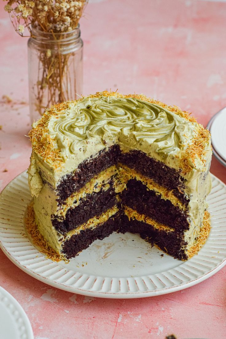 there is a cake that has been cut in half on the plate and ready to be eaten