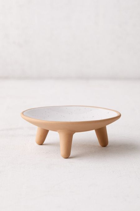 a small white plate sitting on top of a table