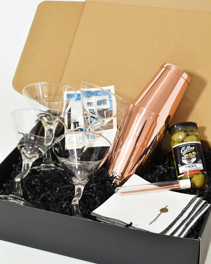 a box filled with wine glasses and condiments