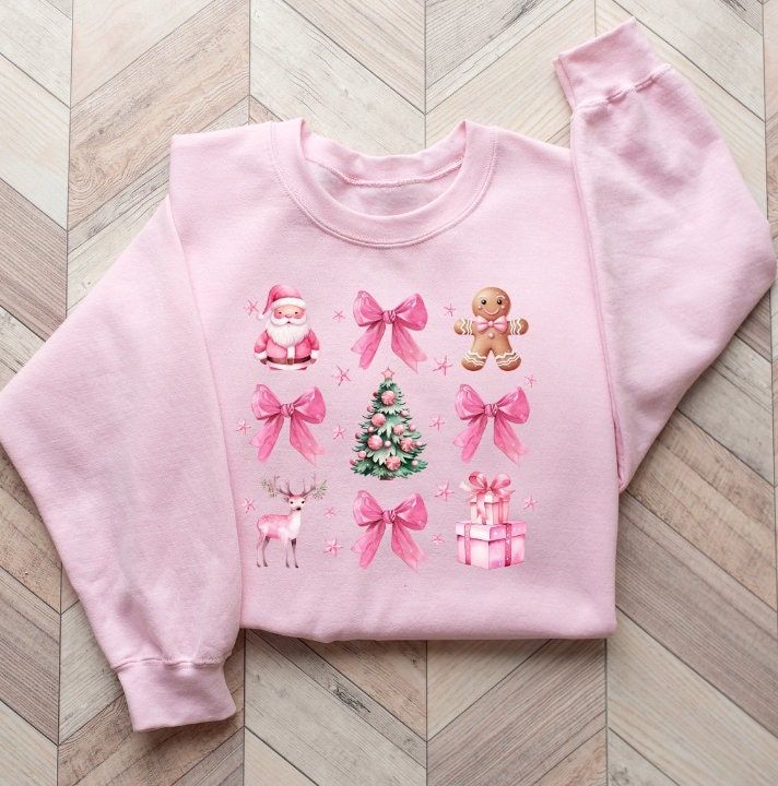 Celebrate the holiday season with a touch of festive charm and a nod to awareness in our cozy Gildan 18000 crewneck sweater. Adorned with pink ribbons and delightful pink Christmas graphics, this sweater is perfect for spreading holiday cheer. ❤  FEATURES  ❤ * Premium Quality: Made from a soft and durable blend of materials, this long-sleeved tee offers both comfort and warmth, making it ideal for the winter season. * Playful Design: The graphic features rows of pink ribbons intertwined with whimsical pink Christmas graphics such as gingerbread men, Santa Claus, and Christmas trees. It's a playful and heartwarming design that stands out during the holiday season. *  Unisex Fit: Designed with a classic unisex fit, it suits all body types and genders. For a relaxed fit, consider sizing up. * Christmas Holiday Crew Neck Sweater, Cozy Christmas Sweater With Crew Neck, Cozy Christmas Crew Neck Sweater, Cozy Crew Neck Holiday Sweater, Cozy Crew Neck Sweater For Holiday, Festive Holiday Crew Neck Sweater, Festive Holiday Sweater With Crew Neck, Cozy Christmas Holiday Sweater, Festive Cozy Crew Neck Sweater