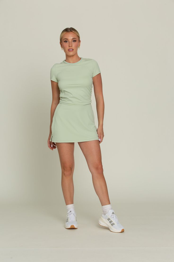 Our Pastel Green Simple Skort is designed for both style and functionality. With built-in spandex shorts for added coverage and hidden dual side pockets for convenience, this skort is designed for both style and functionality. Made from quick-dry material, it ensures you stay comfortable and dry during activities. Perfect for golf, tennis, and more, this versatile skort is a must-have for any active lifestyle. Spandex Shorts, Long Crop Top, Pastel Green, Skirt Leggings, Trending Now, Cropped Tank Top, Long Sleeve Crop Top, Bra Tops, Best Sellers