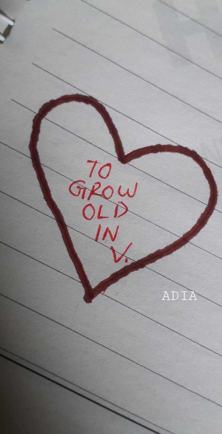 a heart drawn on top of lined paper with the words to grow old in it