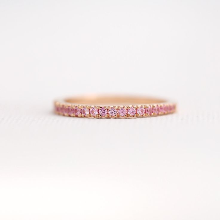 Pink Sapphire Ring, Solid 18K Rose Gold Band, 3/4 Eternity Sapphire Wedding Band, Stacking Ring, September Birthstone Ring, Anniversary Ring ♥ Details Handmade to order * Genuine Pink Sapphire Band in 3/4 eternity * Gemstone type: Natural Light Pink Sapphires * Total Carat Weight: 0.44 carats * Sapphire size: 1.5mm each * Sapphire Cut: Round Brilliant fully Faceted Diamond Cut * Metal: Solid 18K Gold (available in 14K and 18K White, Yellow, and Rose Gold, and 950 platinum) * Ring size: US 3-10 ( Wedding Pink Sapphire Ring With Round Band, Wedding Stackable Rings In Yellow Gold With Pink Sapphire, Wedding Pink Sapphire Diamond Ring With Vvs Clarity, Vvs Clarity Pink Sapphire Diamond Wedding Ring, Rose Gold Pink Sapphire Ring For Wedding, Rose Gold Pink Sapphire Wedding Ring, Wedding Rose Gold Pink Sapphire Ring, Wedding Stackable Pink Sapphire Rings In Fine Jewelry Style, Pink Sapphire Stackable Ring For Wedding