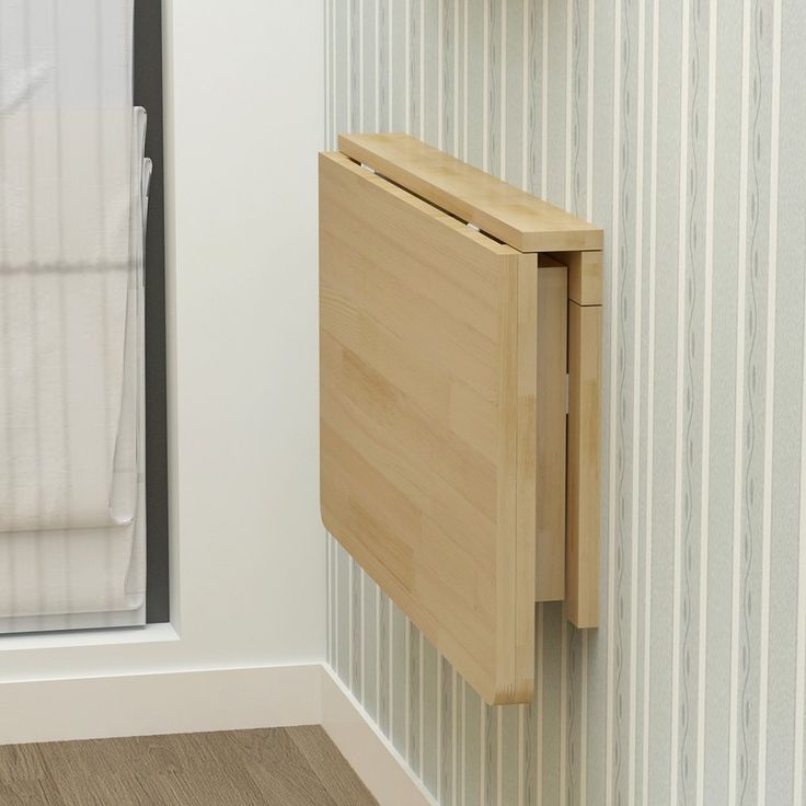 a bathroom with a wooden cabinet next to a shower door and toilet paper dispenser