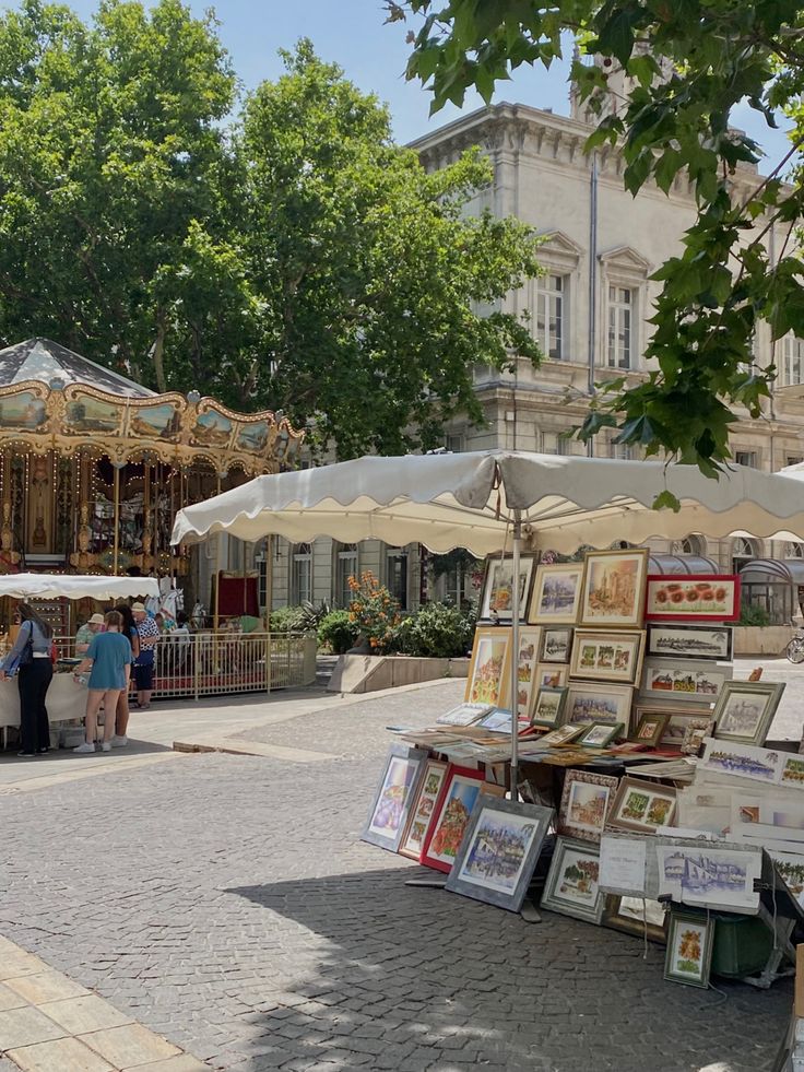 an open air market with lots of pictures on display