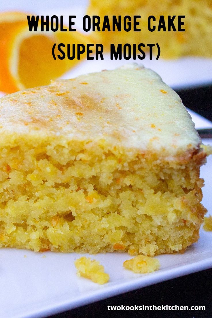 a piece of cake sitting on top of a white plate next to an orange slice