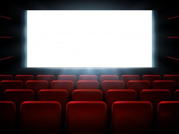 an empty theater with red seats and a white screen