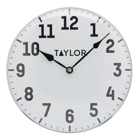 a white wall clock with black numbers on the face is shown in front of a white background