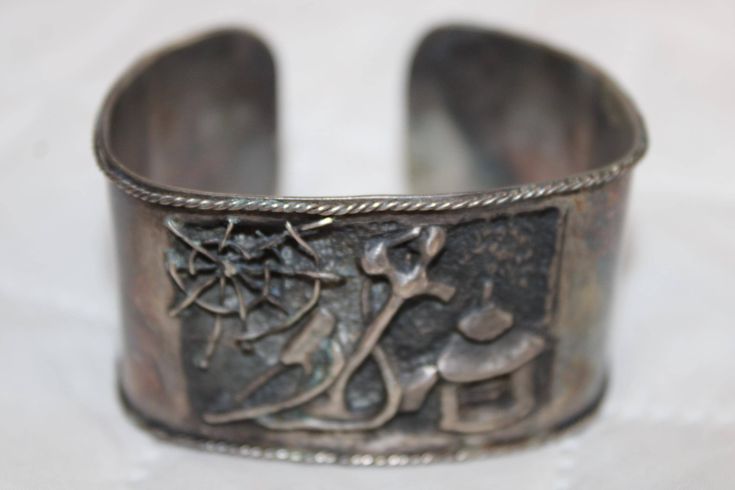 This RARE Vintage bracelet is a showstopper!  It has a picture story engraved with exquisite detail. It is from the 1940's making it a priceless piece of history! This is from a family estate and has been stored in an immaculate, smoke and pet free home. PHOTOS DO NOT DO IT JUSTICE! Please see ALL photos and ask questions before you purchase.  My grandmother was the most loving, honest person in the world and I want her beautiful legacy to live on. So, PLEASE ask questions before you purchase. PLEASE reach out to me first if there is a problem and give me an opportunity to resolve your concern. Thank you and I look forward to connecting with you! Shipping includes careful packaging, insurance, and signature required. Disclaimer: I am not a jeweler, dealer, buyer, nor do I own a store. I am Victorian Etched Cuff Bracelet, Adjustable Victorian Bracelet For Anniversary, Antique Stamped Cuff Bracelet For Formal Occasions, Victorian Engraved Cuff Bracelet For Anniversary, Antique Engraved Cuff Bracelet For Anniversary, Antique Adjustable Cuff Bracelet For Formal Occasions, Engraved Antique Cuff Bracelet For Anniversary, Antique Etched Cuff Bracelet For Formal Occasions, Vintage Sterling Silver Bracelet For Anniversary