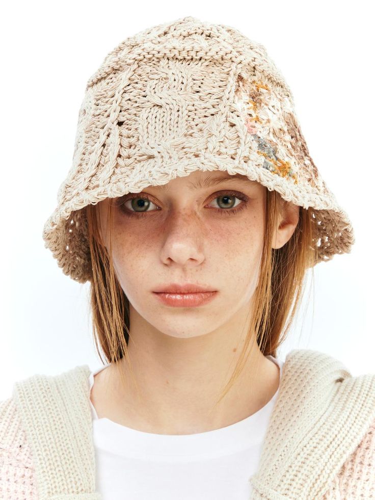 This is a comfortable and casual bucket hat that is made out of sturdy paper and cotton blend knit fabric. With a trendy and unique design with mixed crochet pattern and flower patchwork on the side, it gives a comfortable and casual look. - Paper and cotton yarn knit hat- Flower patchwork on the side- Unique crochet knit pattern Brown Crochet Knitted Hat For Spring, Casual Woven Yarn Bucket Hat, Bohemian Brimmed Beige Bucket Hat, Casual Hand Knitted Spring Hats, Beige Yarn Hat For Spring, Knitted Cotton Bucket Hat For Vacation, Beige Crochet Beanie For Beach, Casual Hand Knitted Bucket Hat For Spring, Casual Knitted Cotton Sun Hat