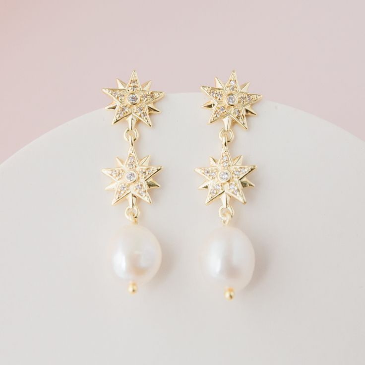 CELESTE // Gold celestial star and pearl drop earrings - Gold stars, adorned with cubic zirconias and freshwater pearls.  14k gold plated brass.  Your jewellery comes in a beautiful suedette pouch for safe keeping. Please note, that for hygiene reasons earrings cannot be returned. Celestial Dangle Earrings For Wedding, Celestial Style Drop Earrings For Wedding, Elegant Star-shaped Pearl Drop Earrings, Celestial Silver Earrings For Wedding, Celestial Style Dangle Jewelry For Wedding, Elegant White Star-shaped Pearl Earrings, Star-shaped Pearl Drop Earrings As Gift, Elegant Star-shaped Pearl Earrings, White Star-shaped Earrings For Wedding