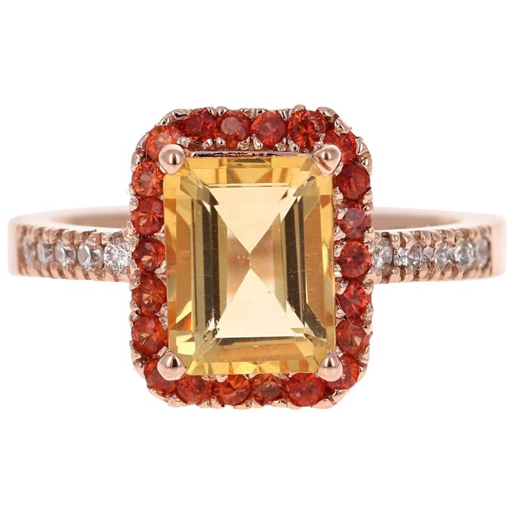 This gorgeous ring has a beautiful Emerald Cut Citrine Quartz weighing 2.23 Carats and is surrounded by a Halo of 22 Round Cut Orange Sapphires weighing 0.50 Carats. Along the shank of the ring are 10 Round Cut Diamonds that weigh 0.18 Carats (Clarity: SI2, Color: F). The total Carat weight is 3.35 Carats. It is set in 14K Rose Gold and weighs approximately 4.9 grams. This ring is a size 7 and can be resized at no additional charge. Luxury Orange Emerald Cut Jewelry, Luxury Gold Emerald Ring With Round Cut, Cut Orange, Sparkling Jewelry, Ring Rosegold, Gorgeous Ring, Razzle Dazzle, Engagement Ring Sizes, Orange Sapphire