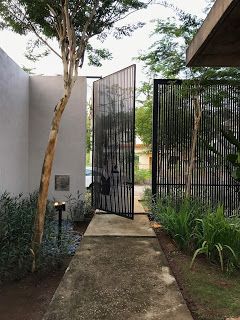 an entrance to a house with black iron gates