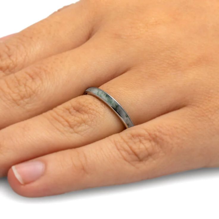 a person's hand with a ring on it