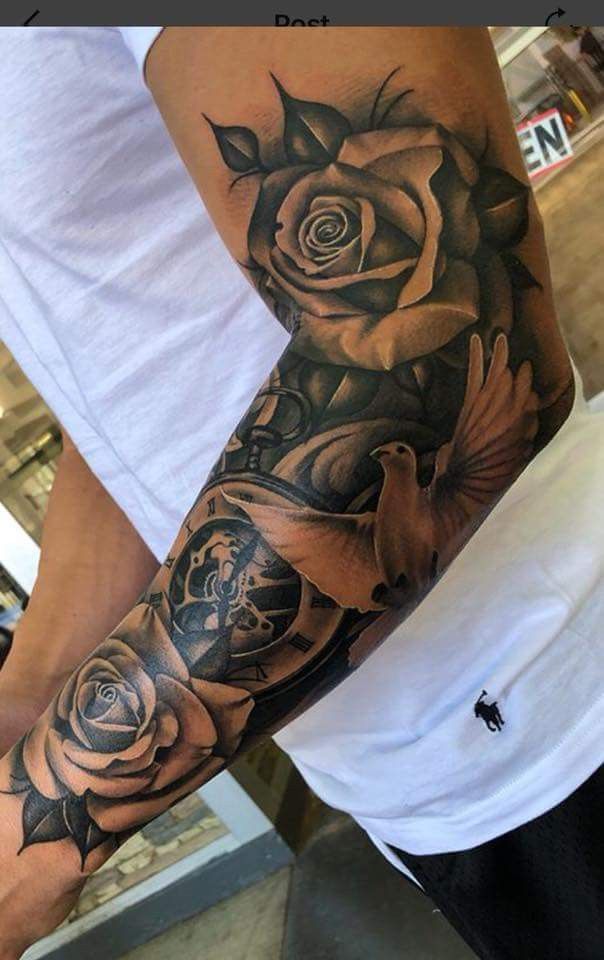 a man's arm with tattoos on it and roses in the middle of his arm